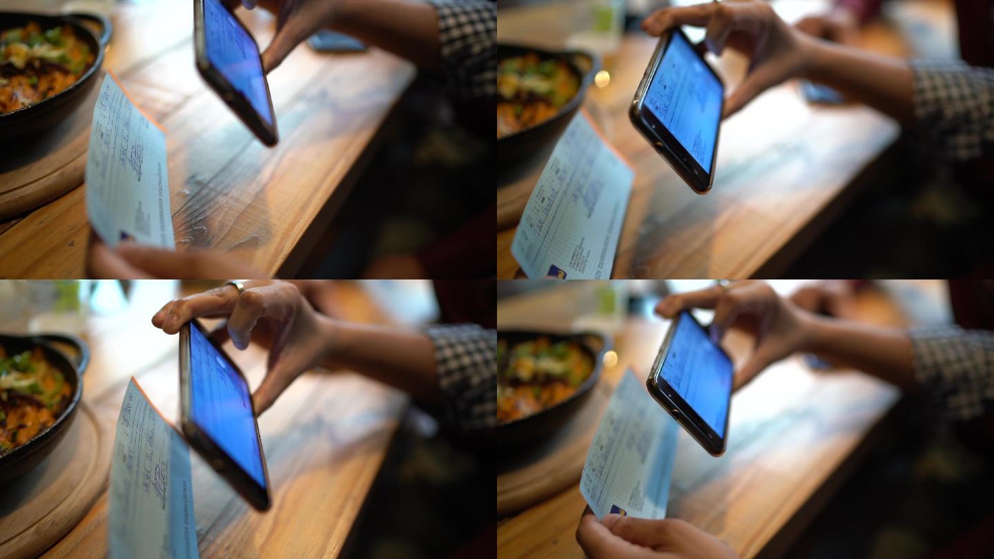 男子在餐厅用电话拍摄支票