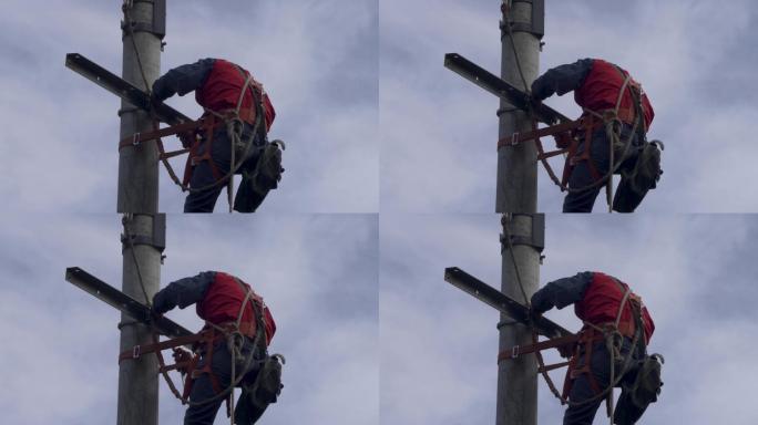电力抢修人员爬上电线杆顶工作06
