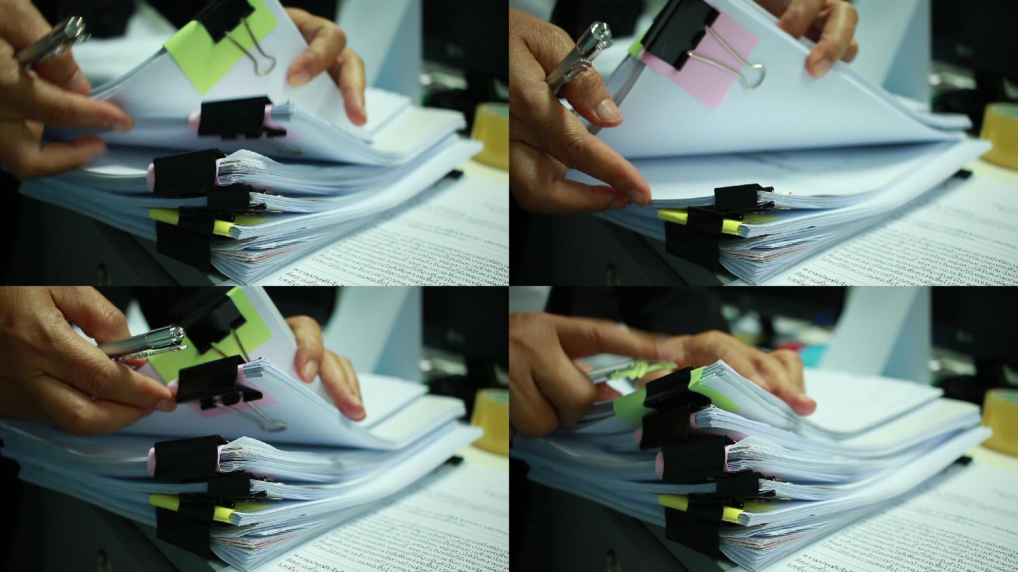 商人在办公室里为财务部门手工处理成堆的文件