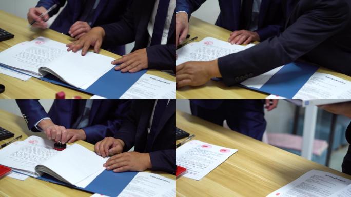【原创】商人在办公桌上合作签约盖章压手印