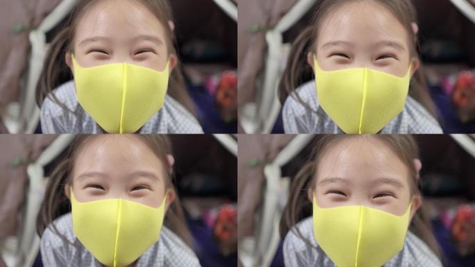 戴口罩的亚洲小女孩微笑