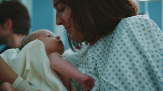 护士在产房将新生儿交给母亲