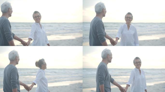 在海边牵手漫步的夫妇