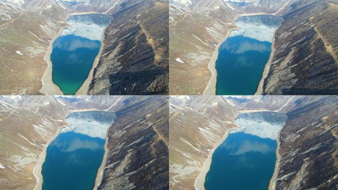 航拍俯视西藏山南雪山倒影的碧蓝色高原湖泊