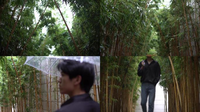 男生在雨天打伞走过长长的竹子长廊