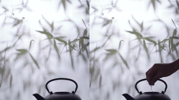 青年人往茶壶里加茶叶和水