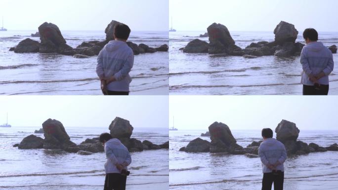 浅滩岩石浪花游客背影