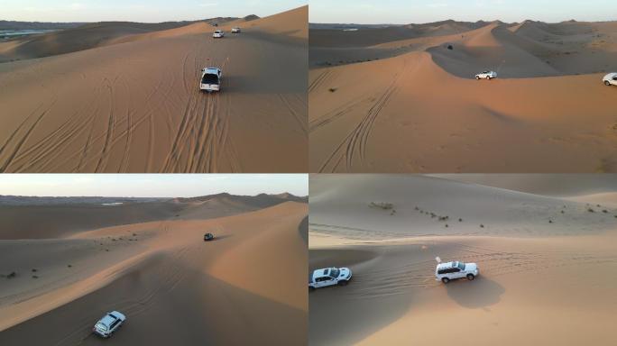 航拍日落穿越沙漠的越野车