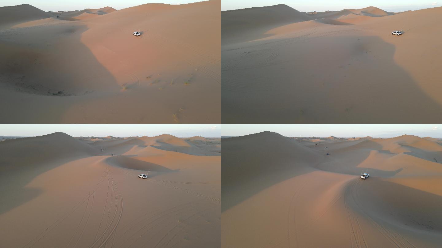 航拍日落穿越沙漠的越野车
