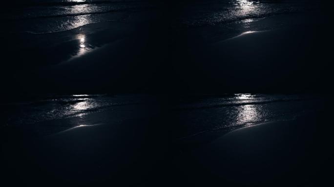 月光下海浪拍打沙滩