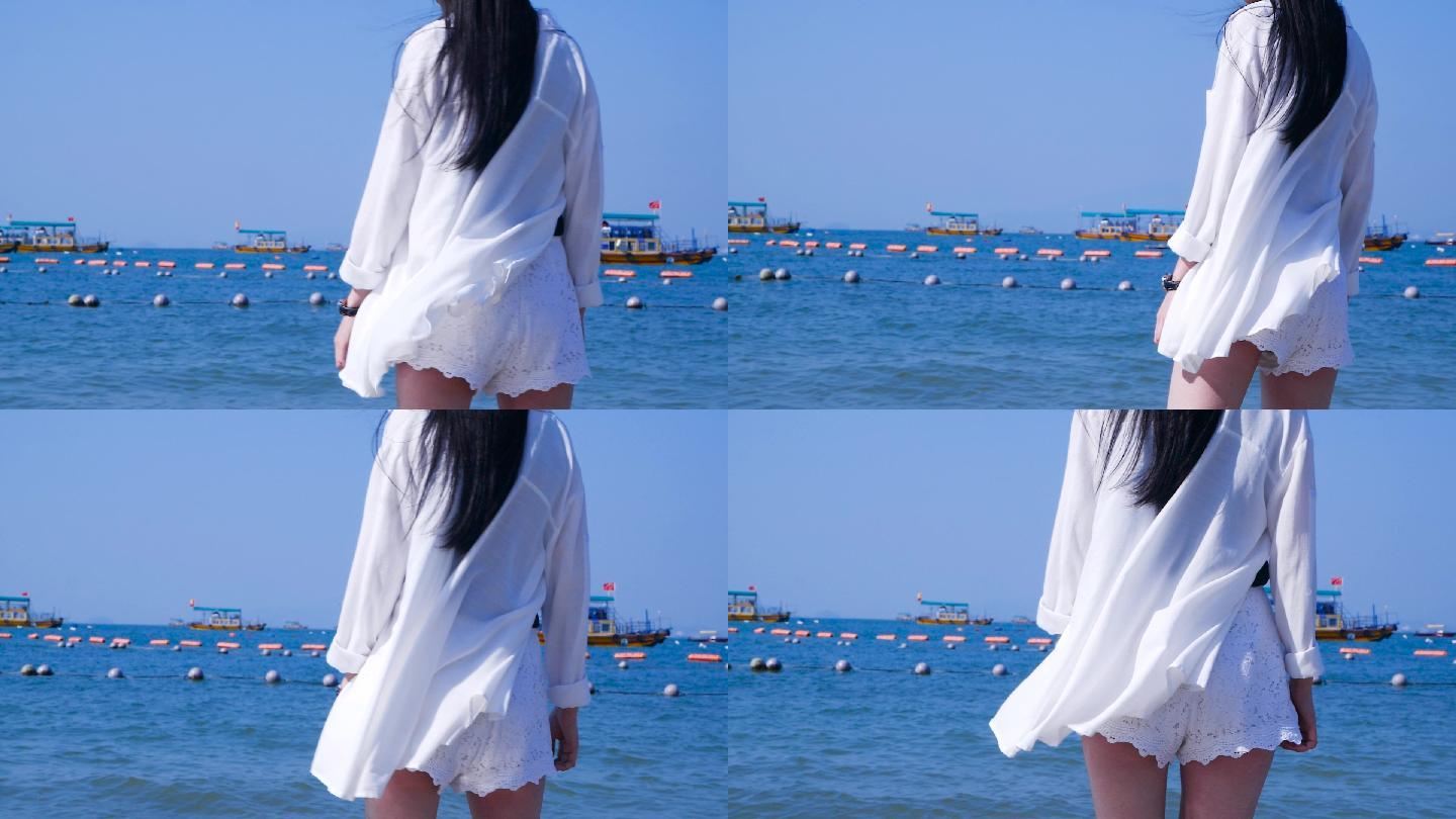 白衣飘飘的女孩在海边漫步的背影