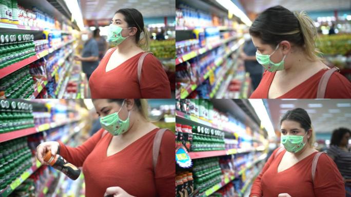 一名妇女戴着一次性医用口罩在超市购物