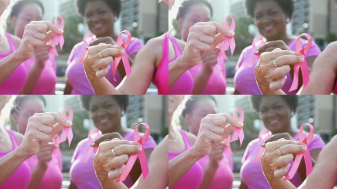 手持乳腺癌意识丝带的女性