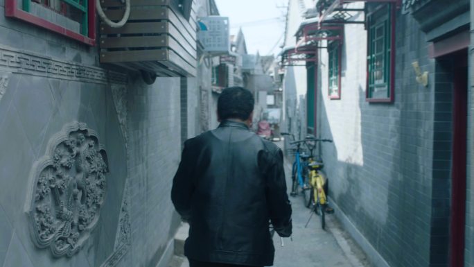 北京后海胡同黑色皮衣男人骑自行车