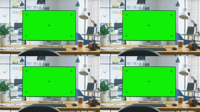 办公室内绿色的台式电脑屏幕