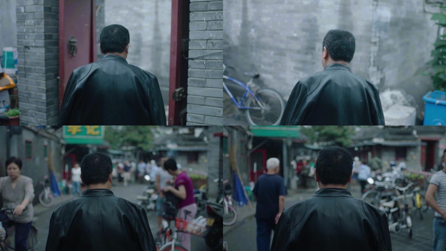北京后海胡同黑色皮衣男人走路