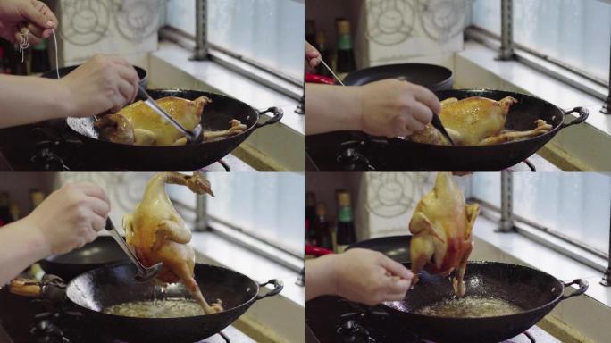 一位厨师在制作家庭炸鸡，炸制整鸡，油淋鸡