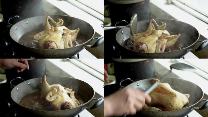 中式厨房里一位厨师在烹煮卤鸭子