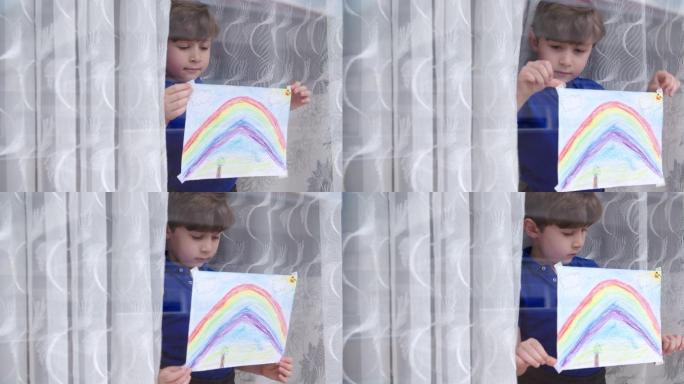 一名男孩画着彩虹贴在玻璃上