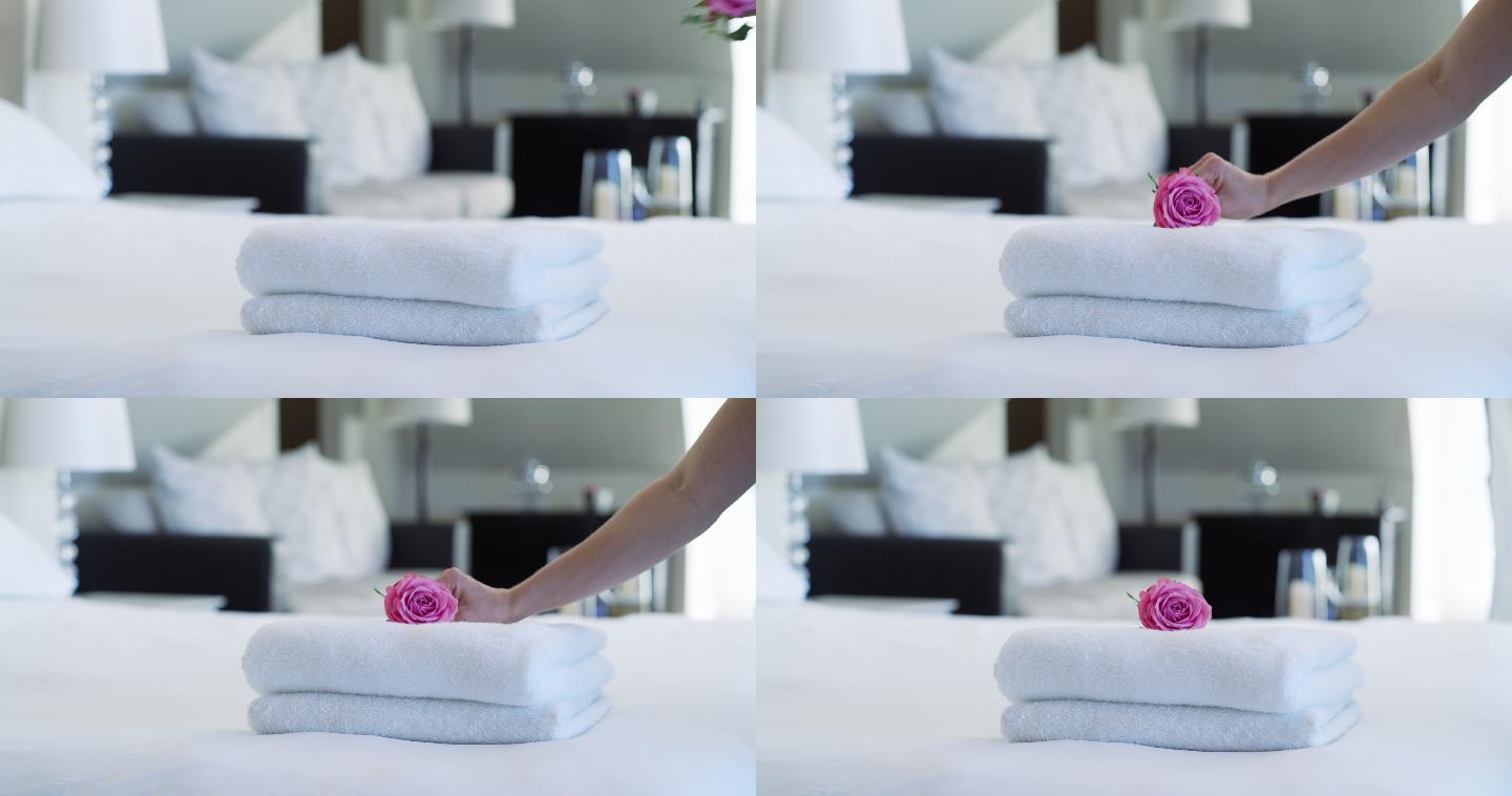 一名妇女将干净的毛巾放在床上