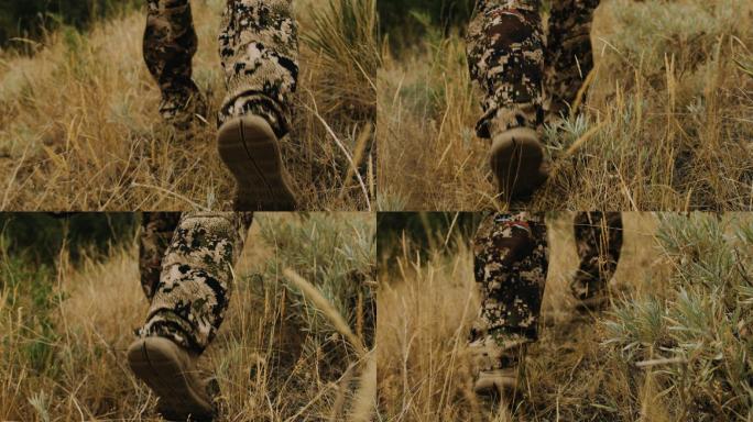 一个猎人穿过野草时脚的特写镜头。