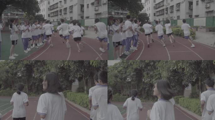 慢镜头中学生在操场跑步
