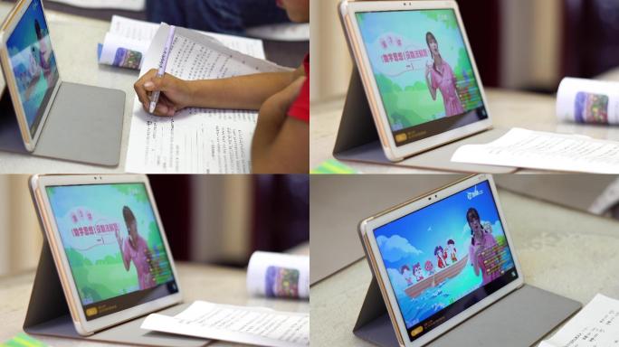 小学生假期在家用平板电脑上网课