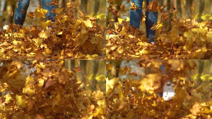 女人顽皮地踢干树叶的镜头。