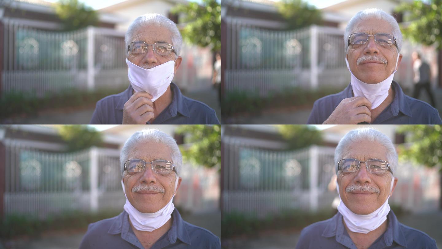 一位老人在街上摘下口罩的画像