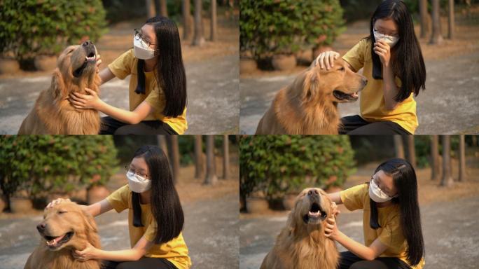 戴着口罩的少女拥抱金毛猎犬