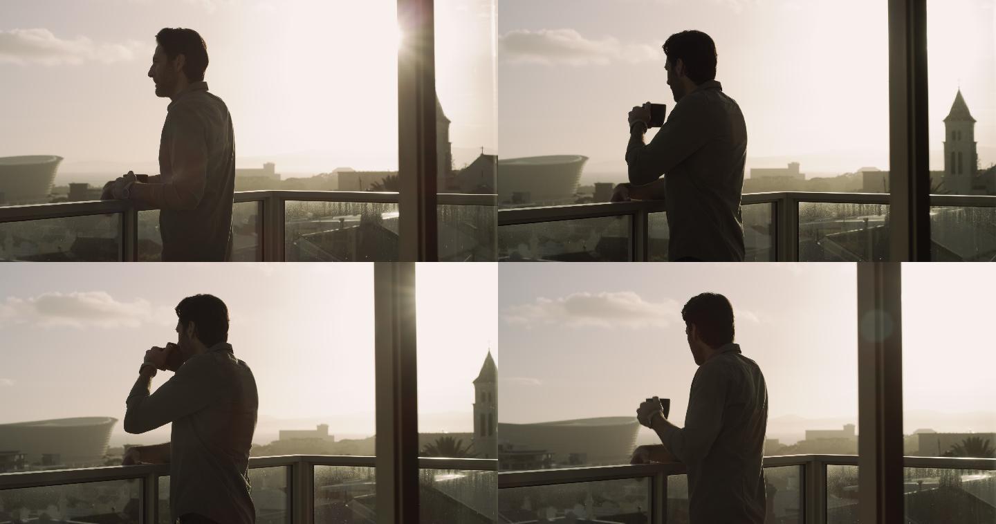 一名男子站在公寓阳台上喝咖啡