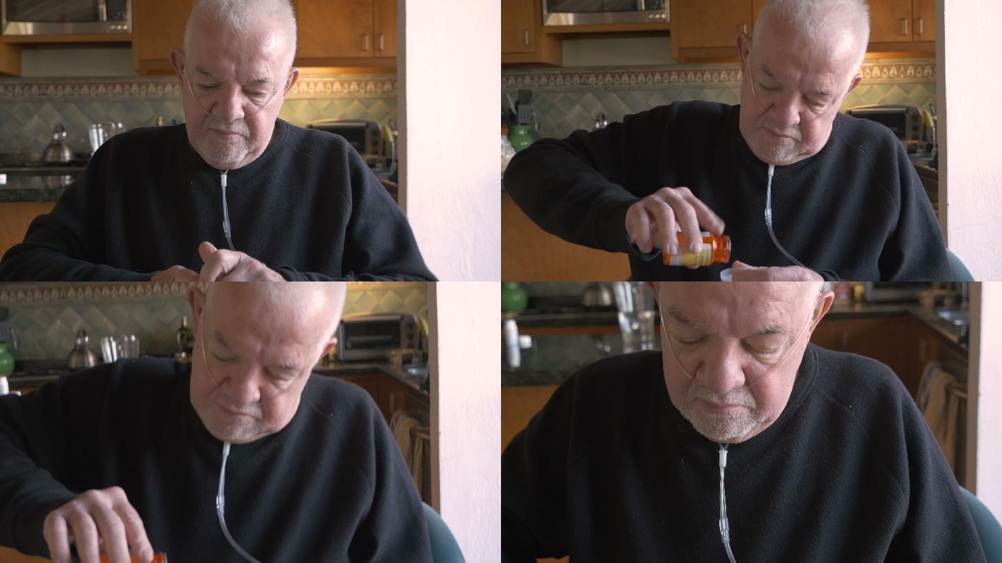 老人戴着氧气从他的处方药瓶里拿药片