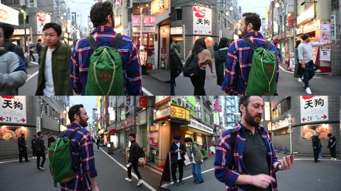 使用app在东京街头行走的游客