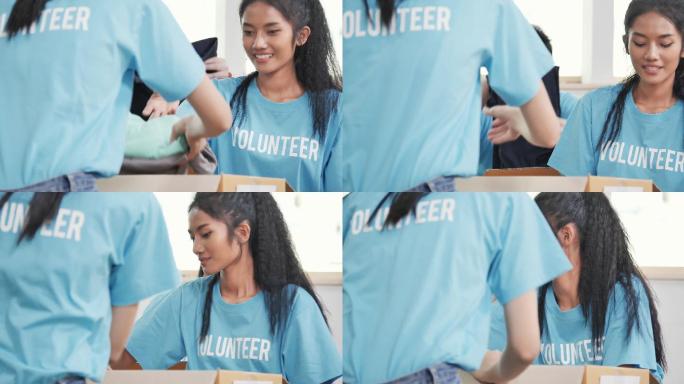 年轻女性志愿者为无家可归的人打包衣物捐款。