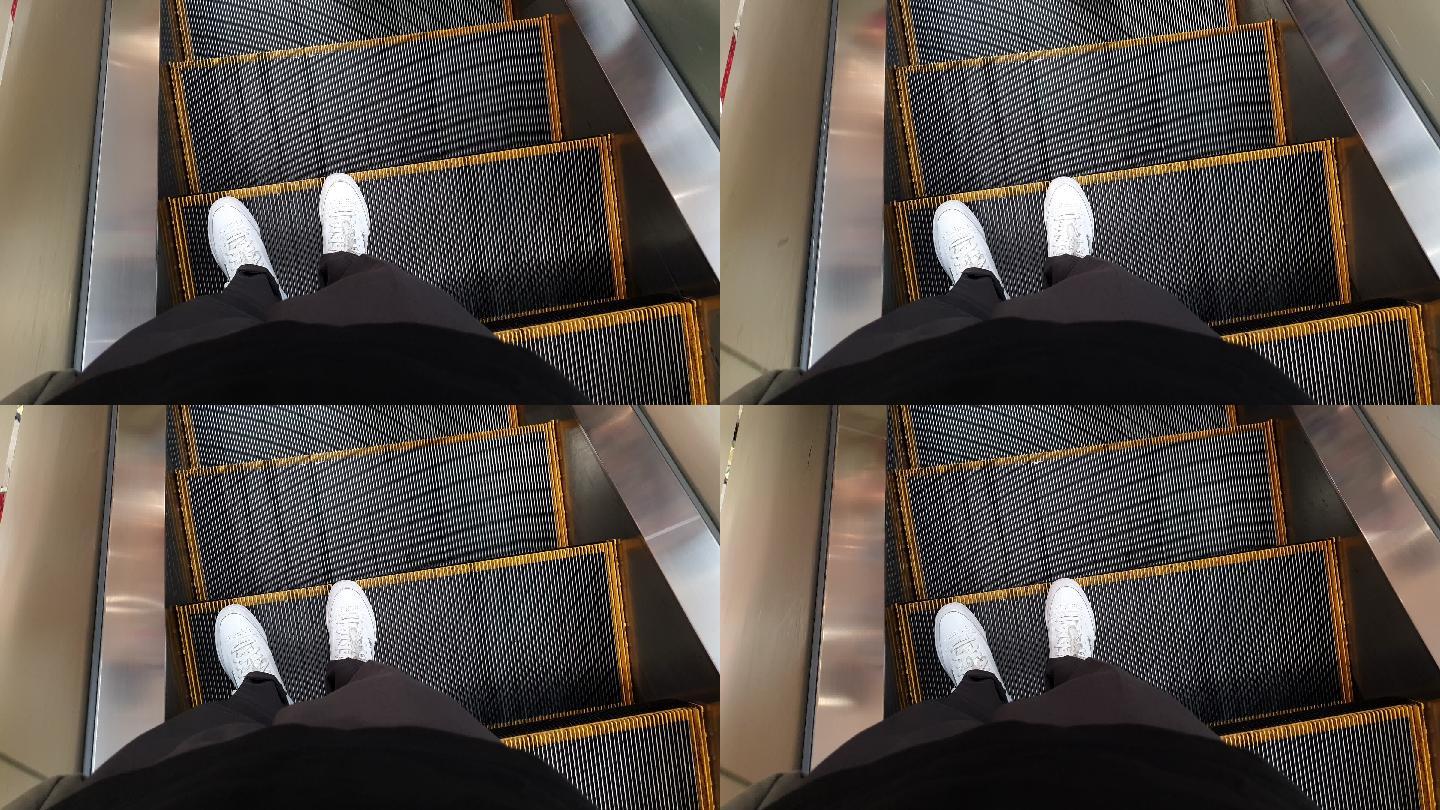 个人视角步行自动扶梯底部台阶步行视角地铁站立到达楼梯鞋旅行台阶和