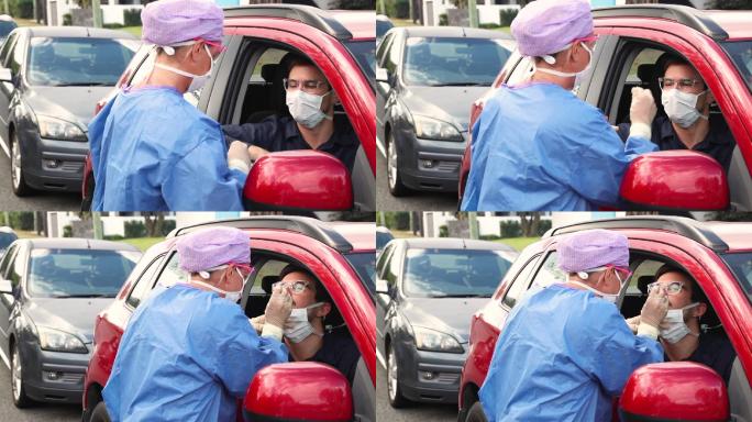 穿着防护服的医生给驾驶员做核酸检测