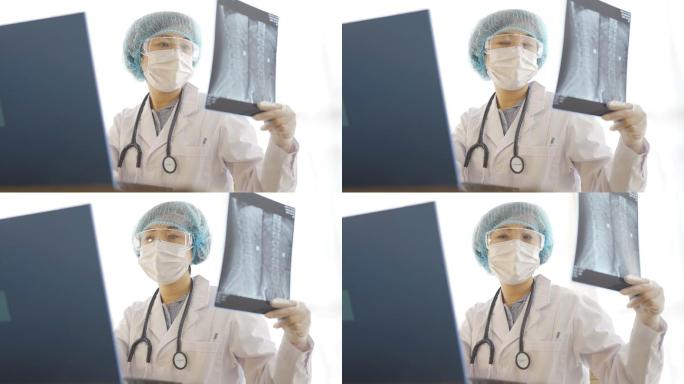 戴着口罩和护目镜的女医生检查x光照片，