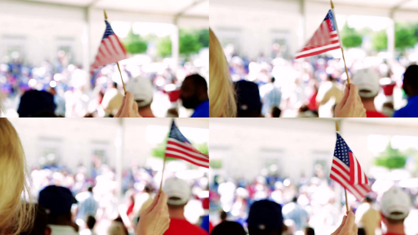 这位妇女在7月4日的游行中挥舞着美国国旗
