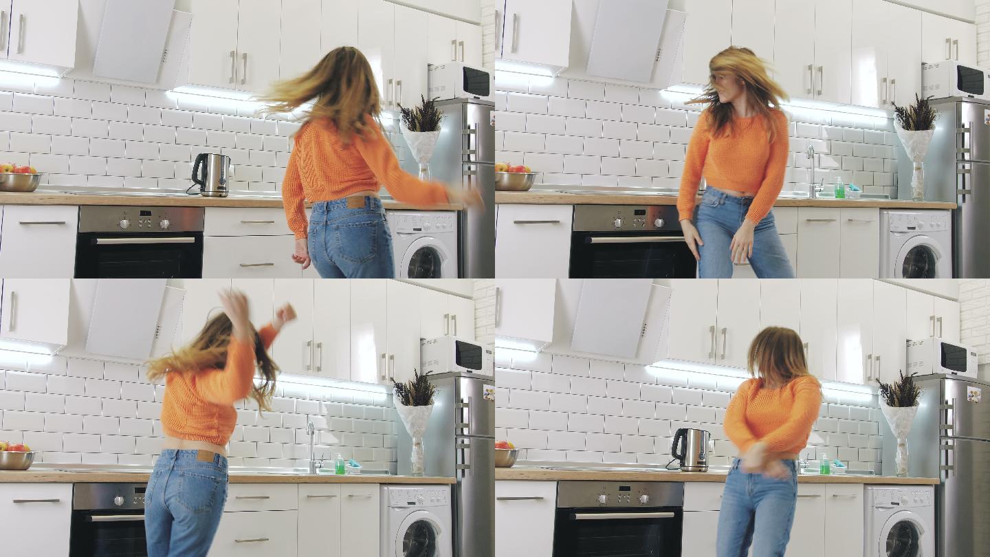 年轻快乐的女人在厨房跳舞，玩得很开心