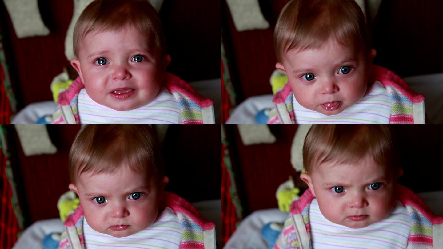 哭泣的婴儿突然停止哭泣，盯着摄像机