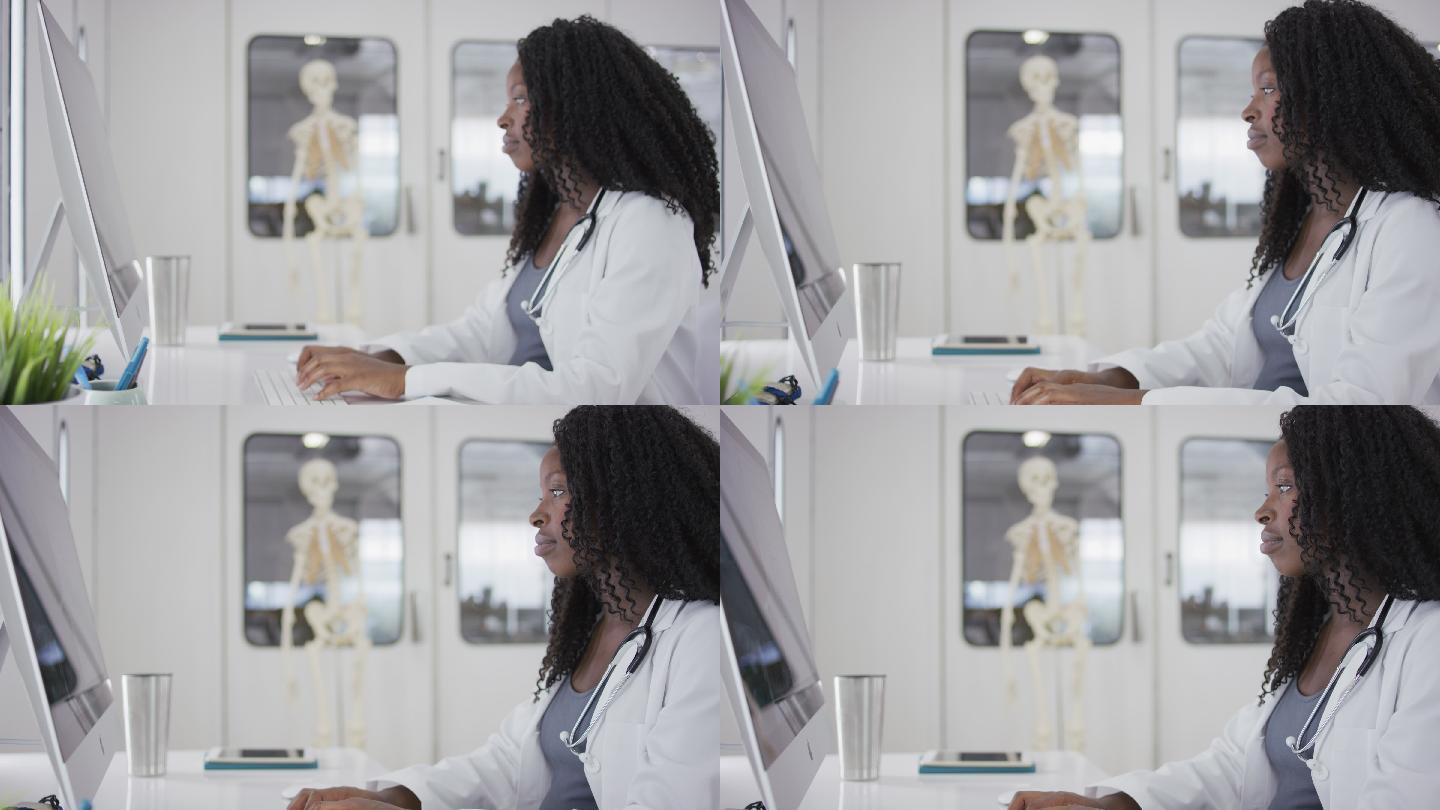 坐在电脑前的非裔美国女医生