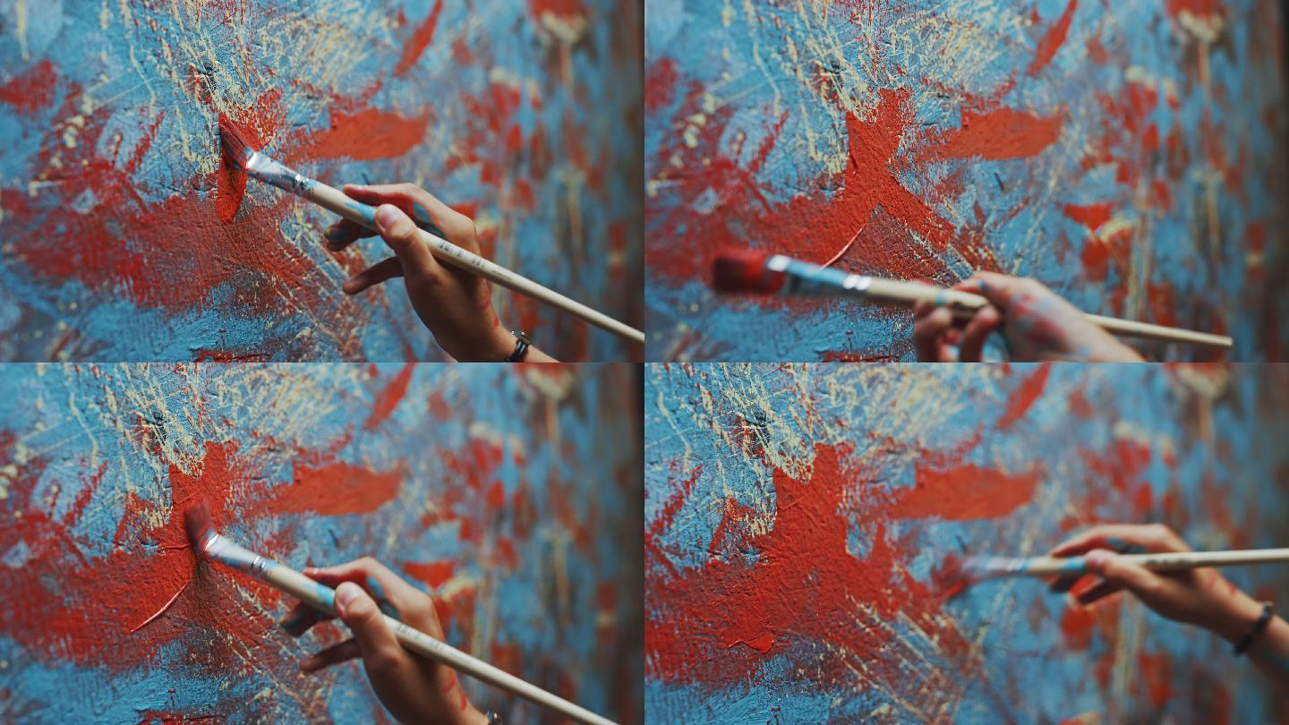 女艺术家手拿画笔，用红色颜料画画