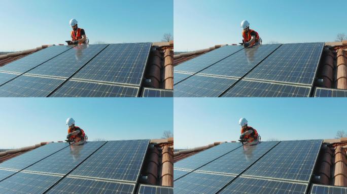 维护安装在家用屋顶上的太阳能光伏板的男人