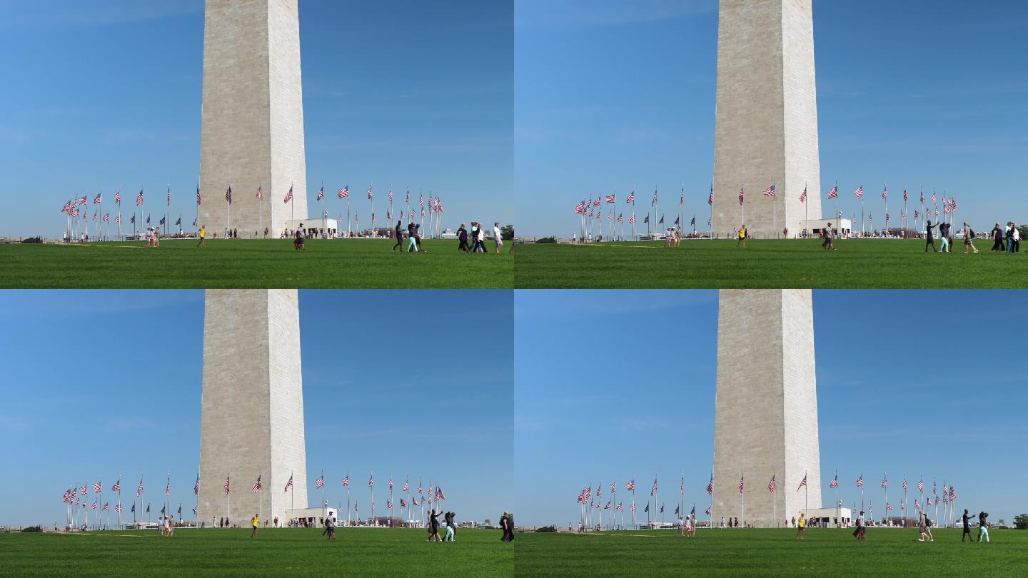 参观华盛顿纪念碑基地的游客的全景照片
