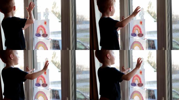 新冠疫情期间，一个小男孩在窗户边挥手