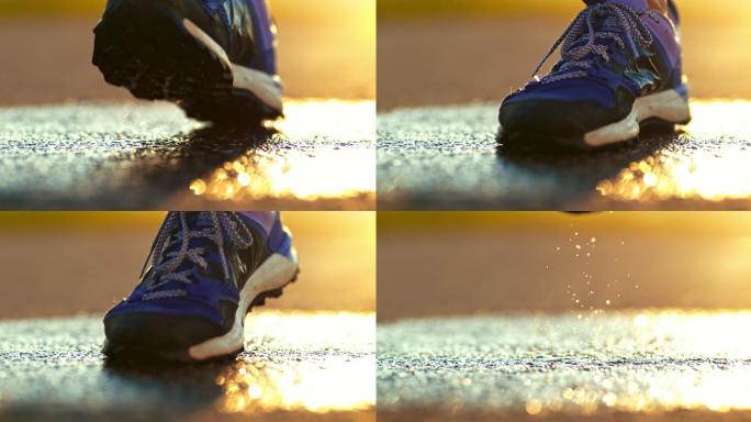 跑步鞋在湿滑的路面上溅起水花