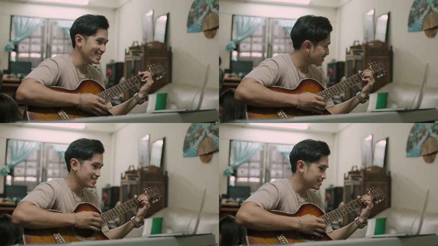 男子在家学习弹吉他