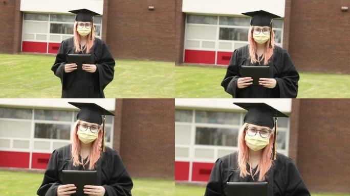 高中毕业生戴着口罩手持毕业证书