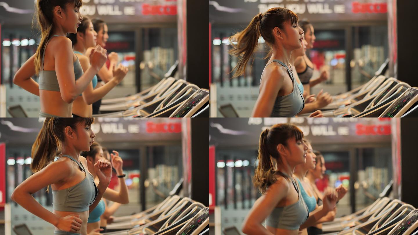年轻漂亮的女子在健身房的跑步机上跑步