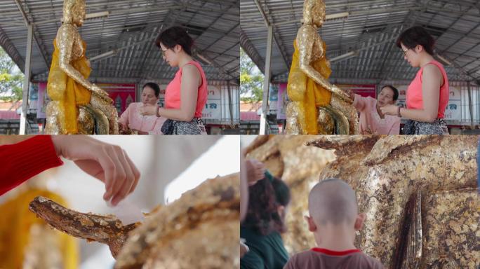 泰国旅游视频泰国民众祈福给佛像贴金身